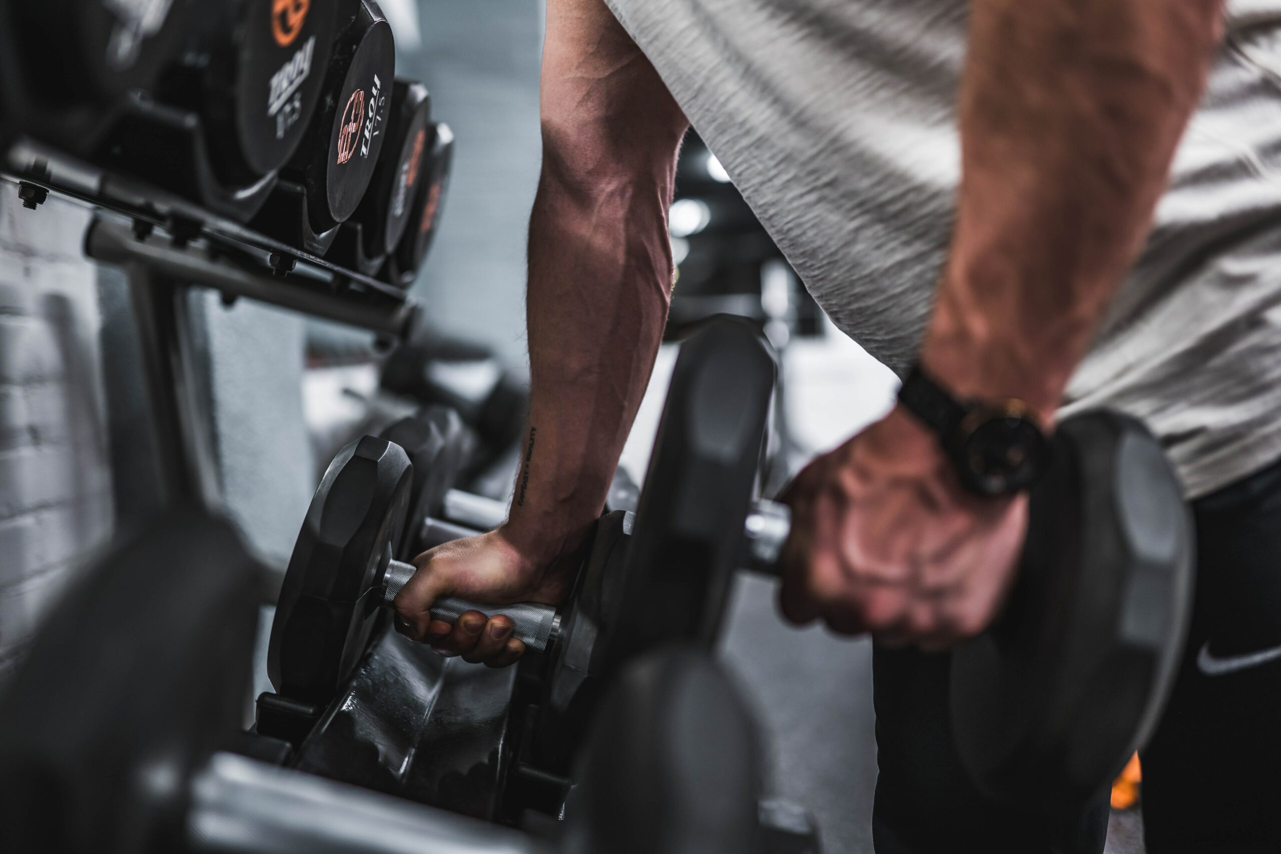 gray scale photo of dumbbells