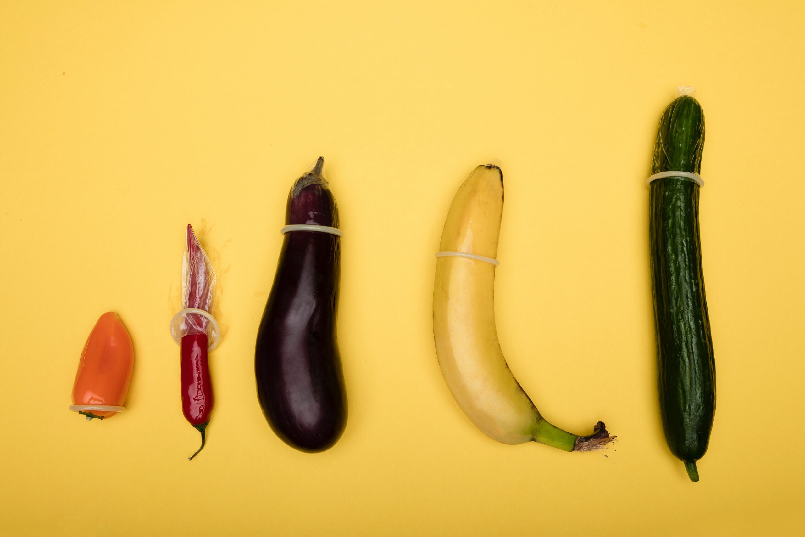 row of fruit with condoms on