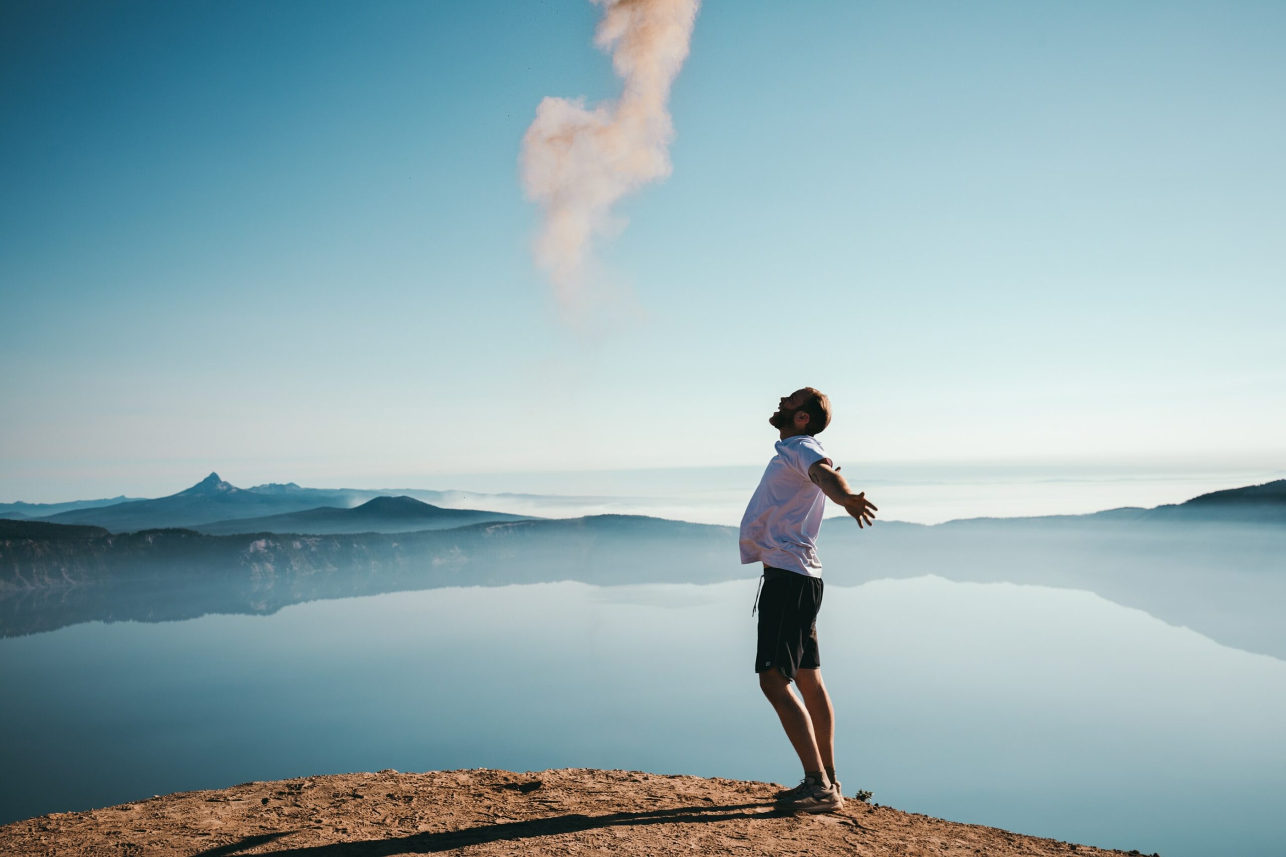 man hiking in front of a lake