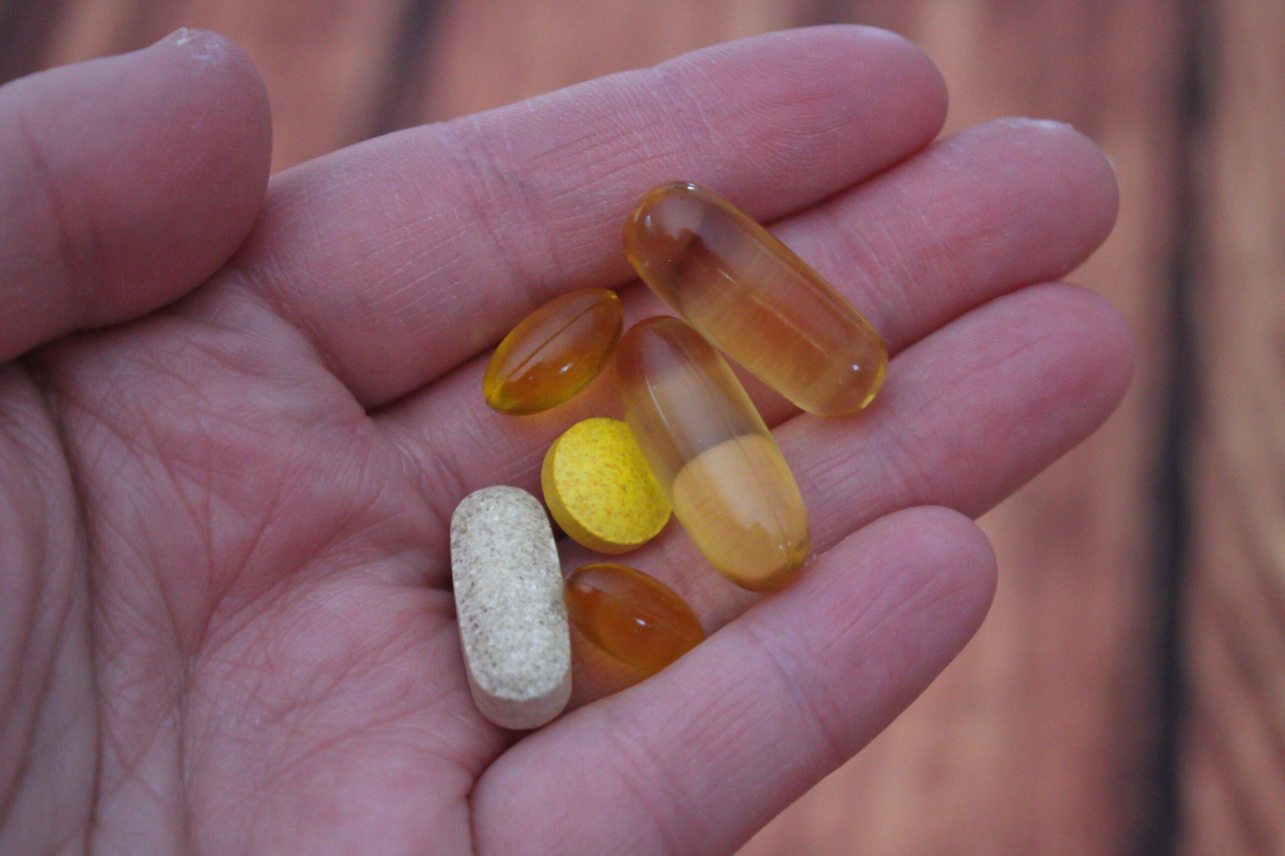 A person holding medication pills