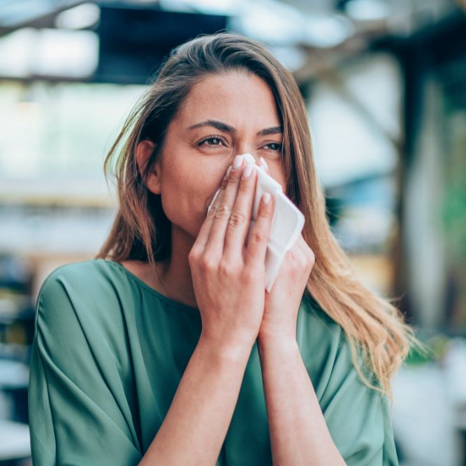 lady blowing her nose using a tissue