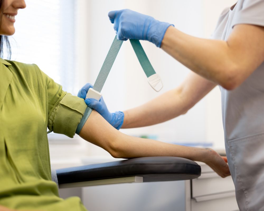 A medical professional giving a blood test to woman